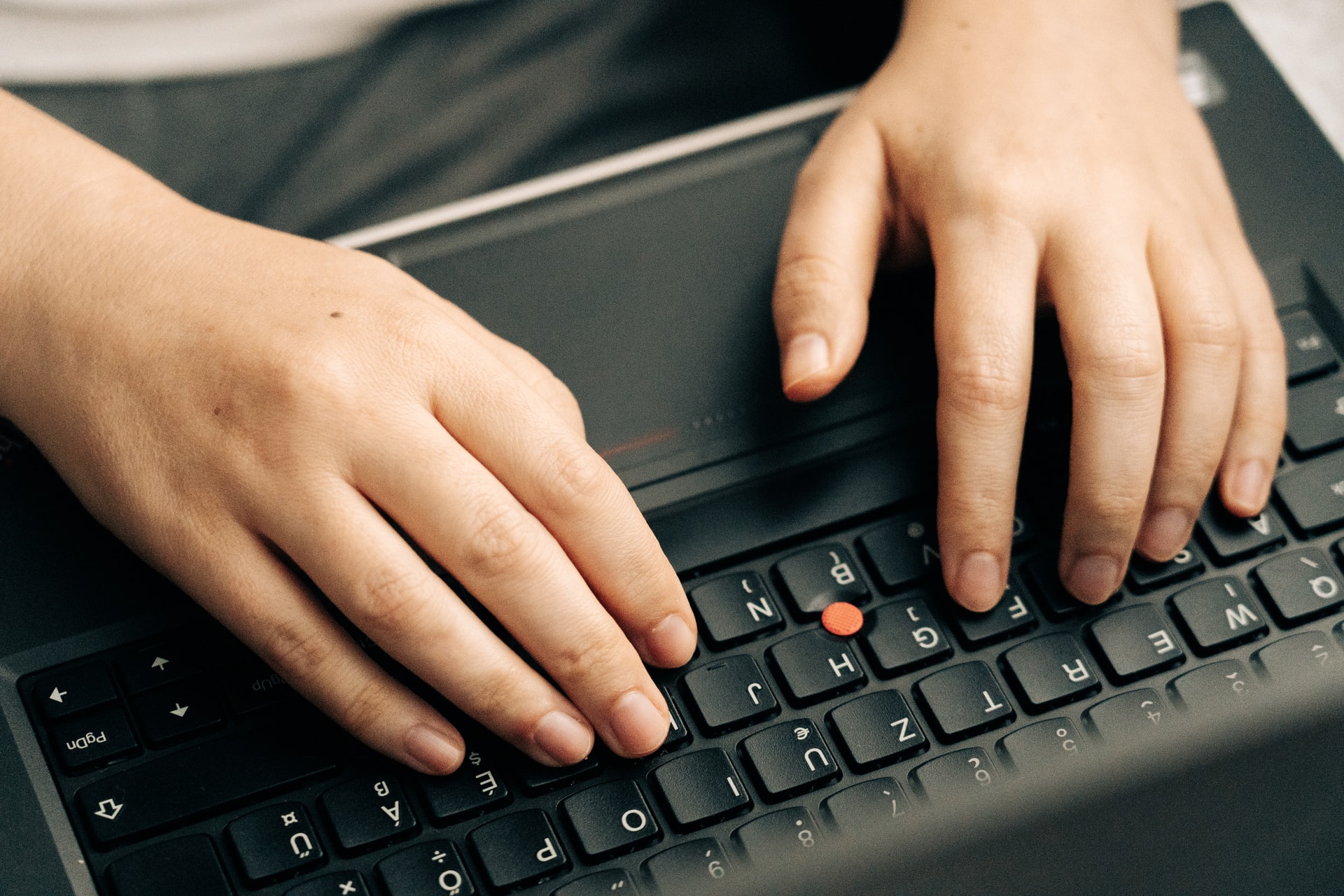 person typing on the laptop