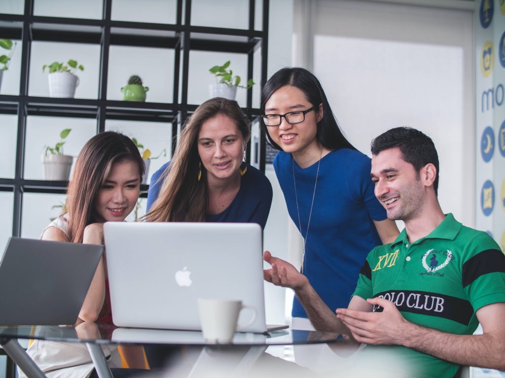 group of people looking at the laptop