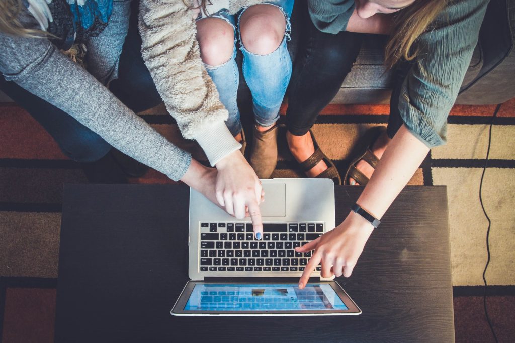 group pointing at laptop