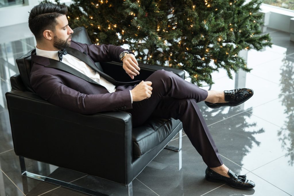 man in suit looking at the watch