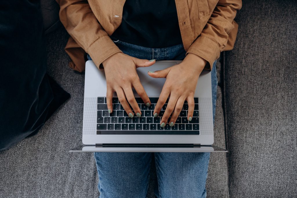 person typing on laptop