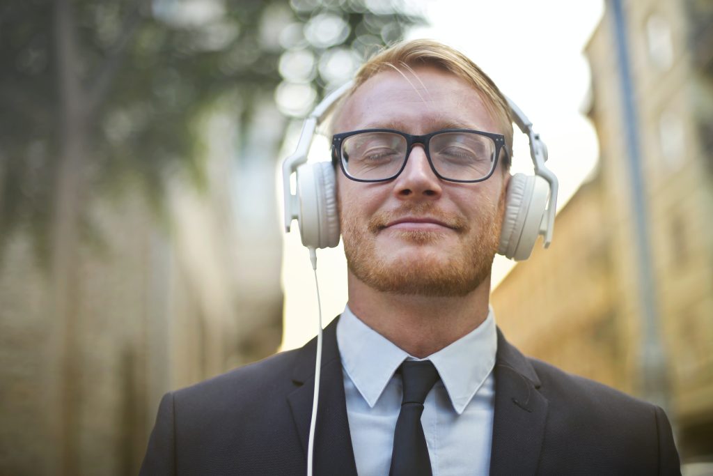 Man in suit listening to audio