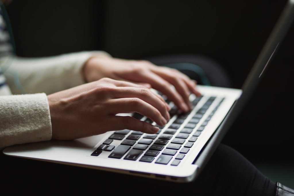 person using laptop to type