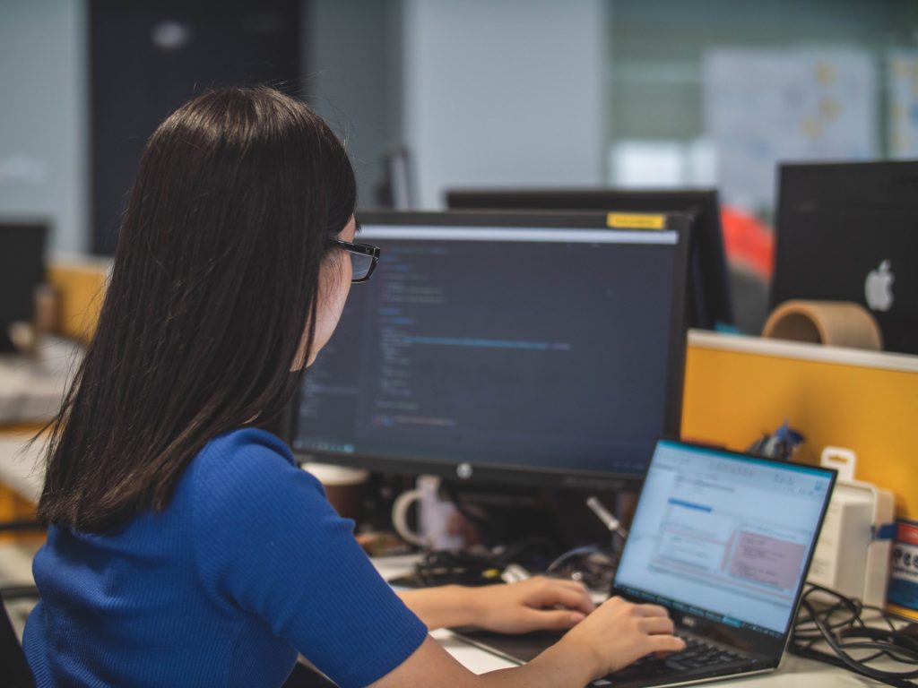 woman using black laptop and pc